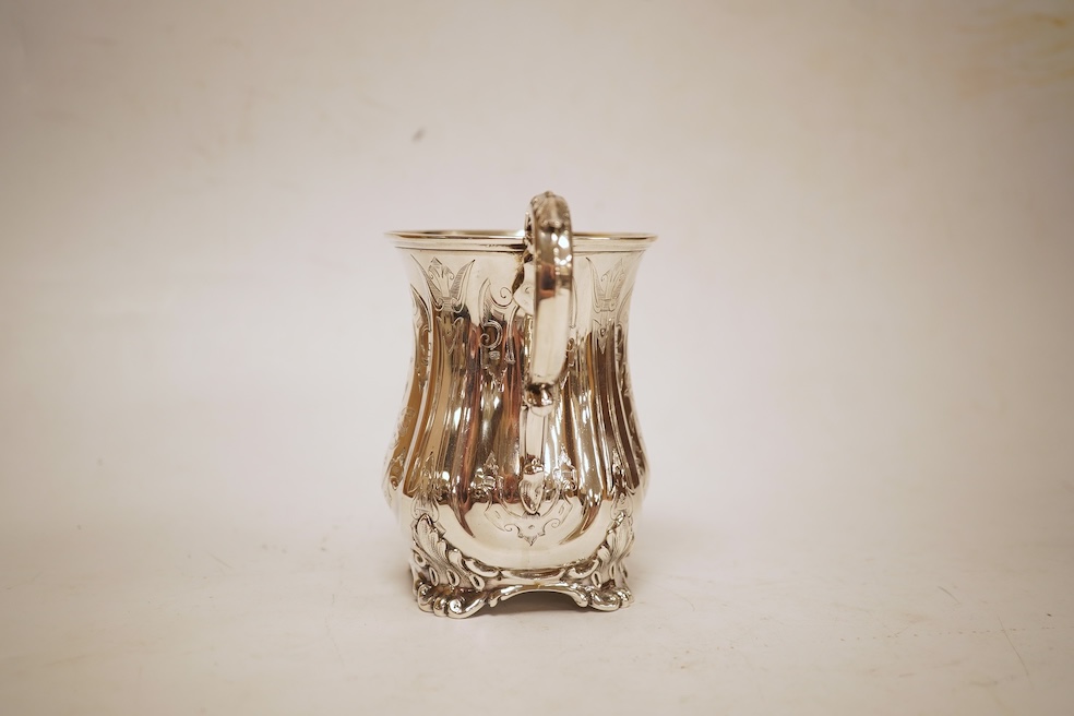A Victorian engraved silver christening mug, with acanthus leaf capped scroll handle and engraved inscription, Martin, Hall & Co, Sheffield, 1856, 11cm, 5.3oz.